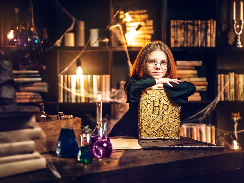 A girl with a harry potter book in the harry potter castle